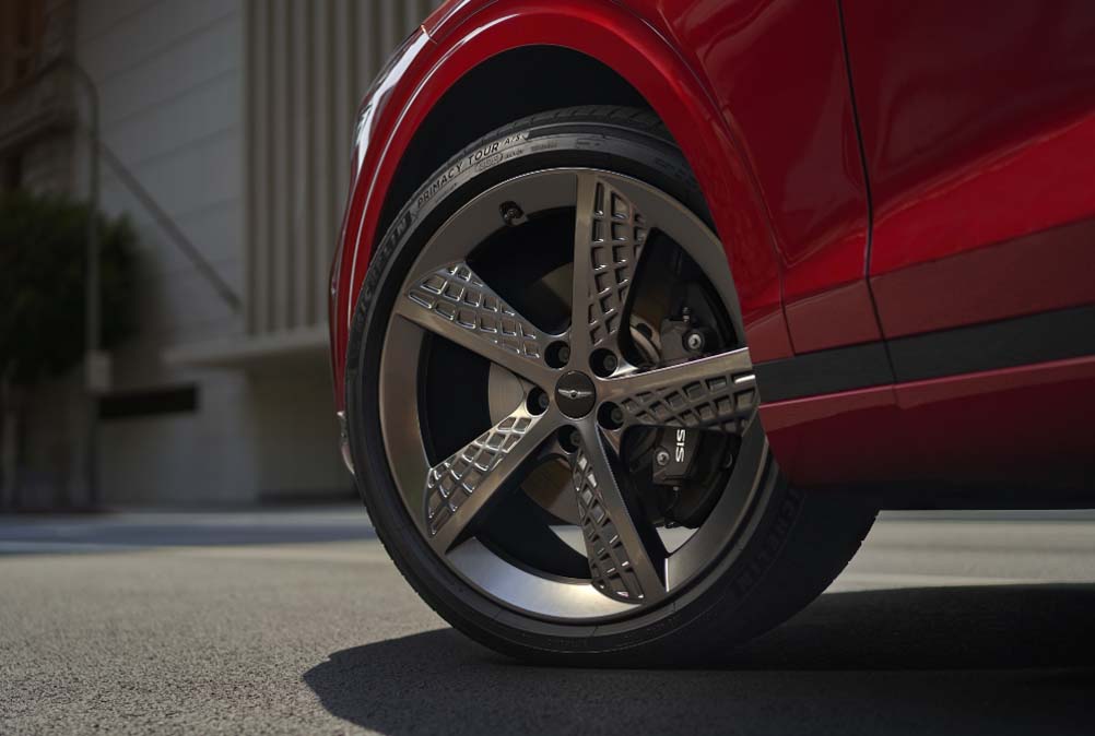 Genecis wheel and tire on red vehicle